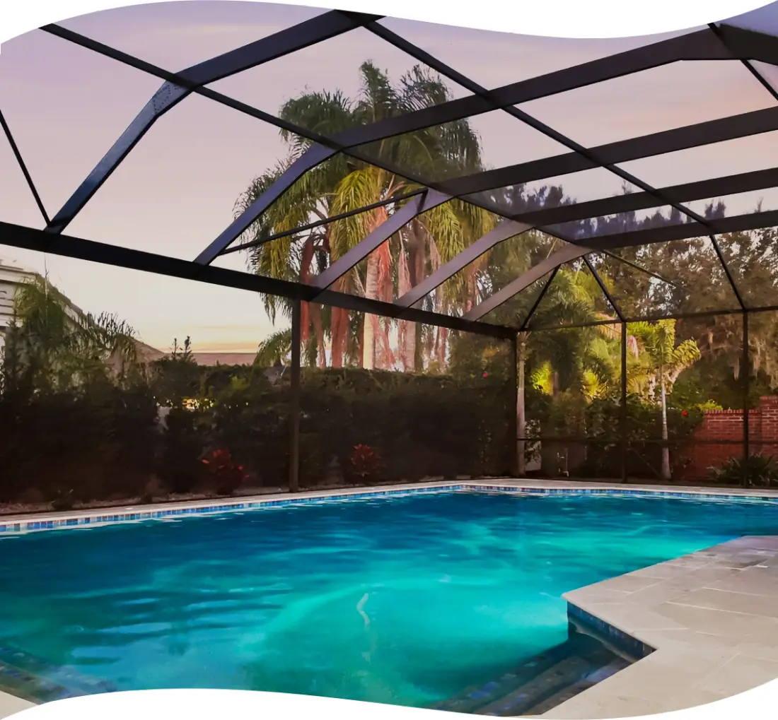 Screened pool with turquoise LED lighting at dusk.