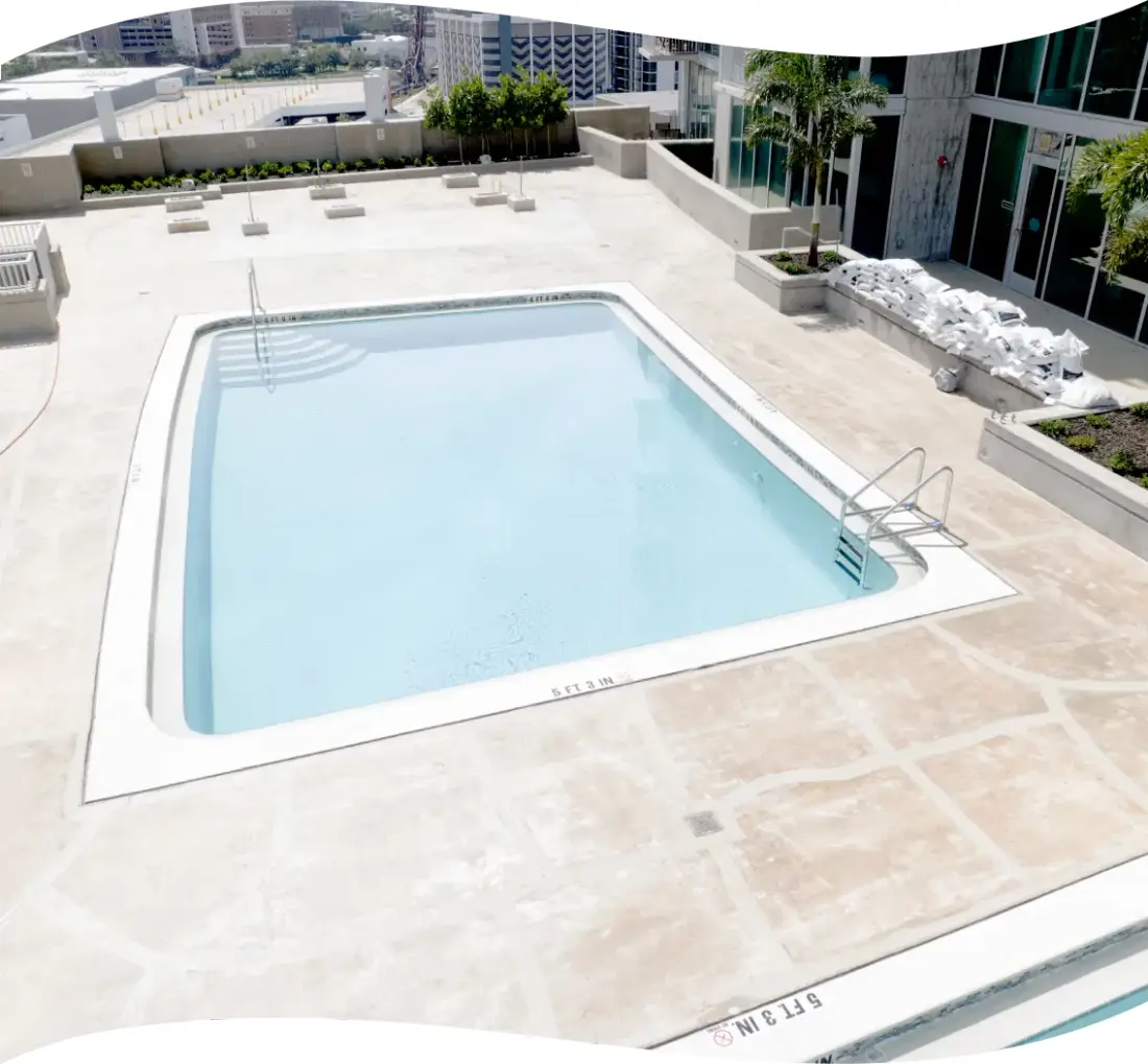 Finished rectangular rooftop pool with clean geometric edges overlooking the city.