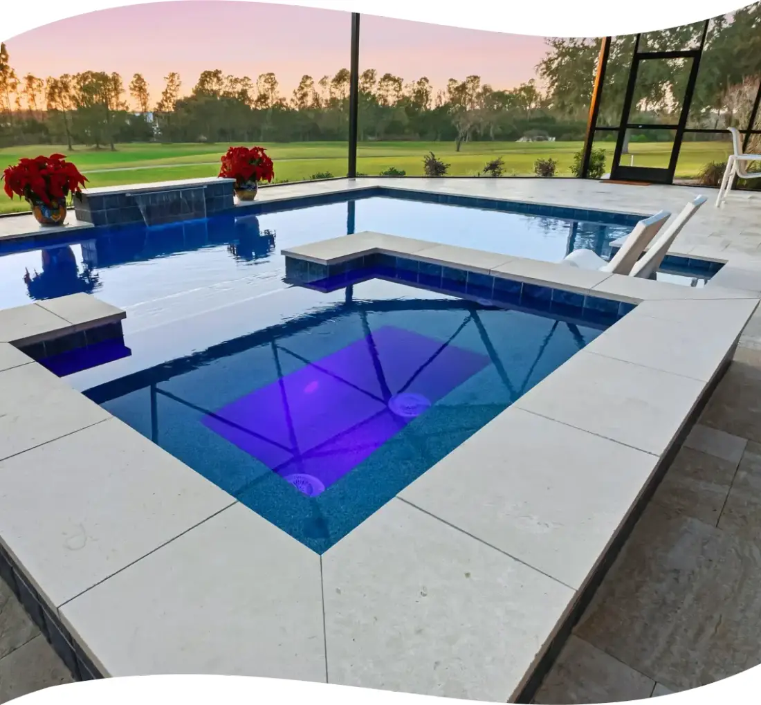 Raised square spa lit with purple LED lighting, travertine steps leading down.