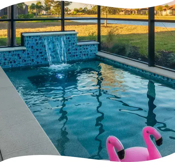 Rectangular pool and raised spa waterfall with a pool float, evening light.