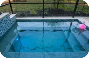 Raised spa lit with underwater LED lighting at night.