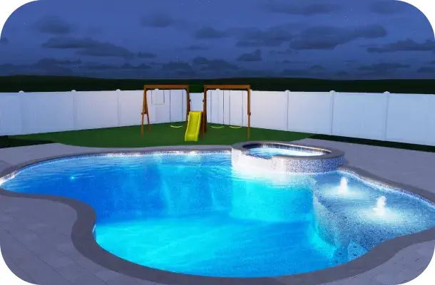 Freeform pool and spa lit blue at night.