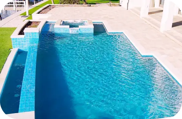 Long pool with a raised spa and steps in a backyard with a pergola.
