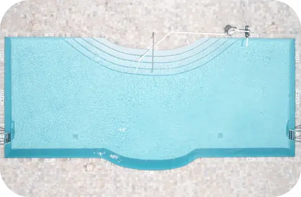 Aerial straight-down view of a curved-edge lap pool.
