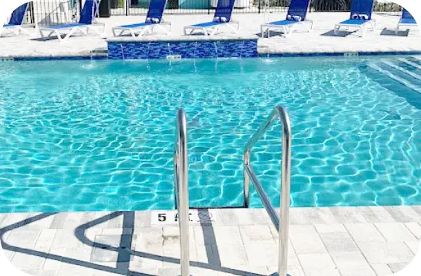 Close-up of the pool's ladder rail, steps, and tile detail.