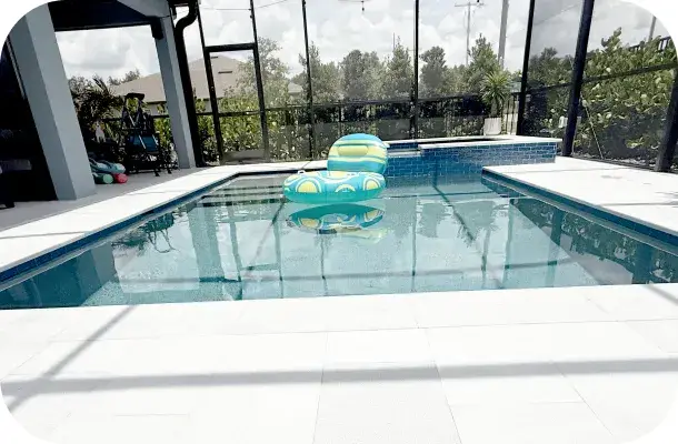 Pool with a floating pool toy beside the raised spa.