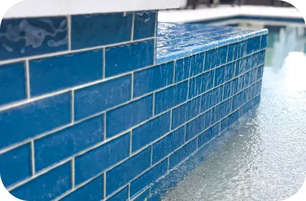 Close-up of the raised spa's blue subway-tile wall.