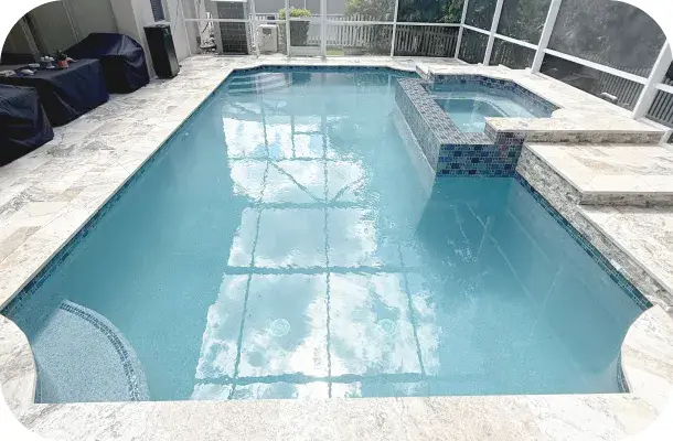 Wide view of the geometric pool and raised spa with patio furniture, pond visible beyond the screen.