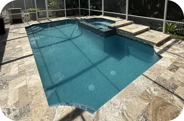 Close view of the pool's geometric edge with morning light on the water.