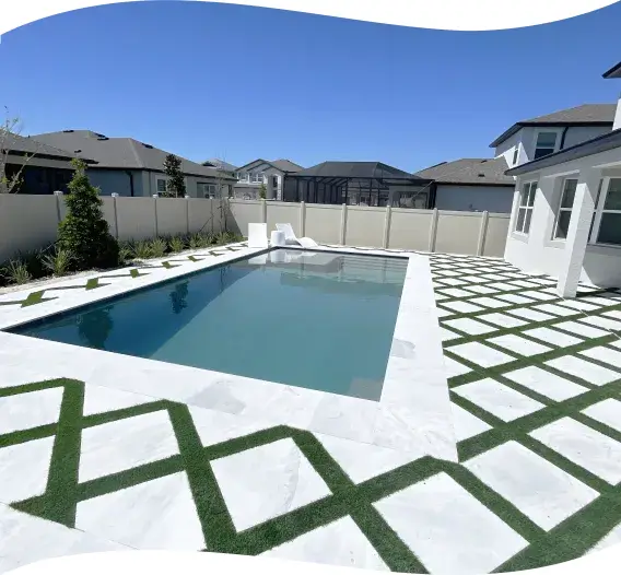 Finished rectangular pool with freshly sodded lawn beside the home.